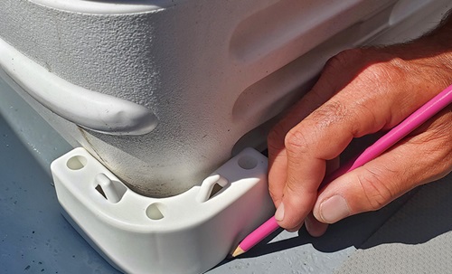 A white cooler's chocks’ positions with a pink grease pencil.