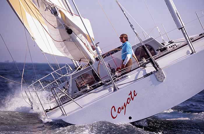 A man at the helm of his sailboat named Coyote