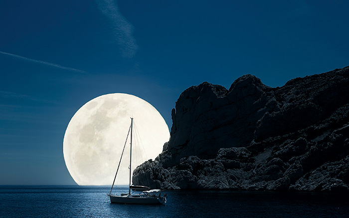 Sailboat Moored at Night with Big Full Moon in Background