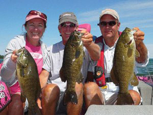 Kerry and Kevin Short and Steve Kennedy holding smallmouth bass caught on Lake Superior