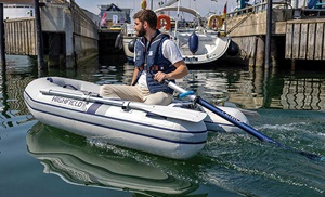 Bearded adult male wearing a navy life jacket in a small white boat using a TEMO 450 electric motor.