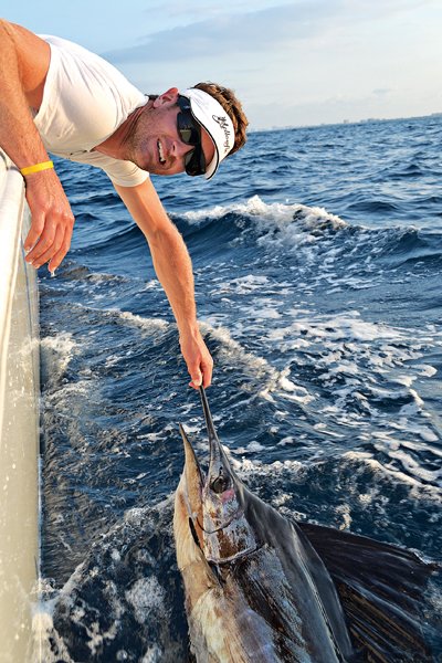 Ryan Hunter-Reay catching a fish.