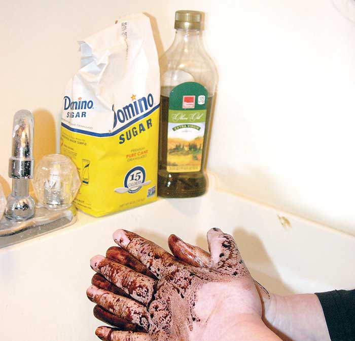 Cleaning dirty hands with olive oil and sugar