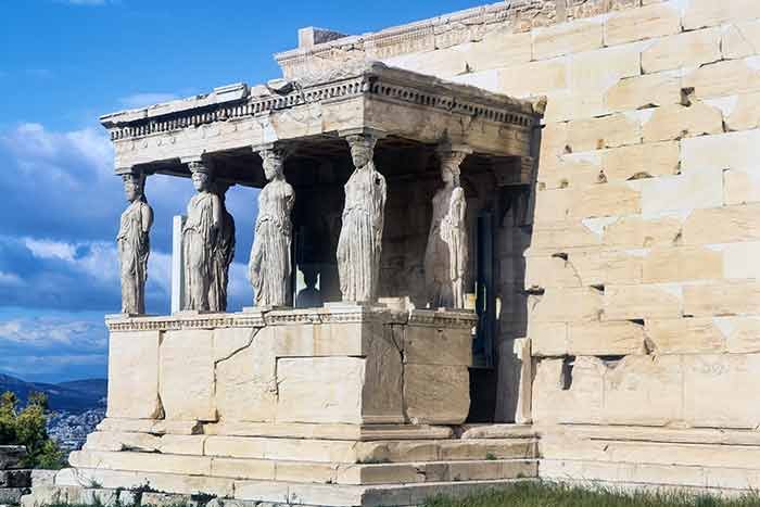 The Acropolis in Athens, Greece - five statues are built into the side of an ancient building