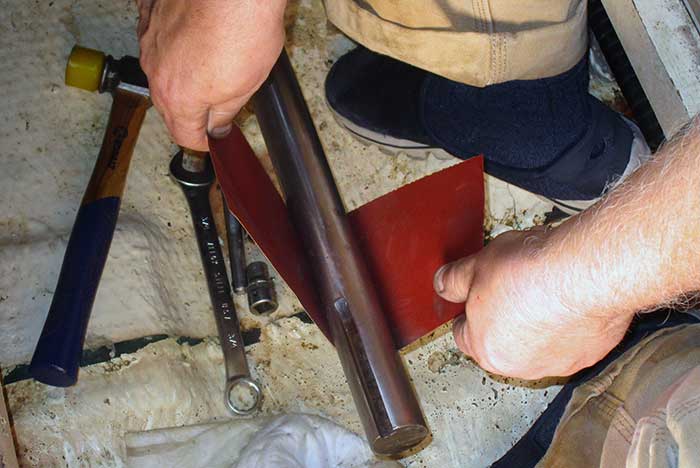 Polishing the shaft with sandpaper