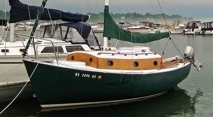 Photo of a home-built sailboat docked.