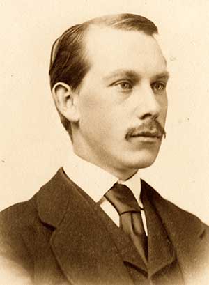 Sepia toned portrait of a gentleman in a suit and tie with mustache