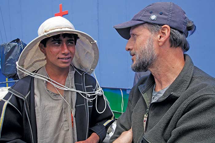 Close-up of two men having a discussion on a film set