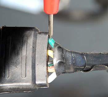 Close up of boat tow vehicle wiring jacket with green wire exposed