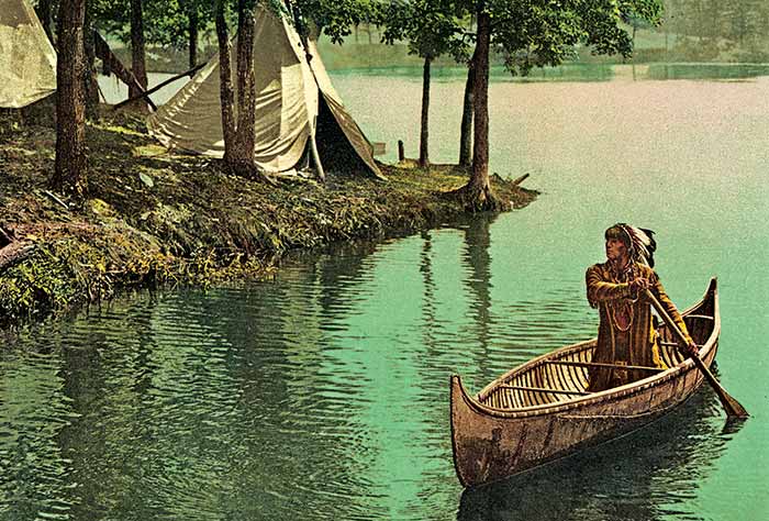  Hiawatha 1900 lithograph showing Hiawatha paddling a canoe down a stream