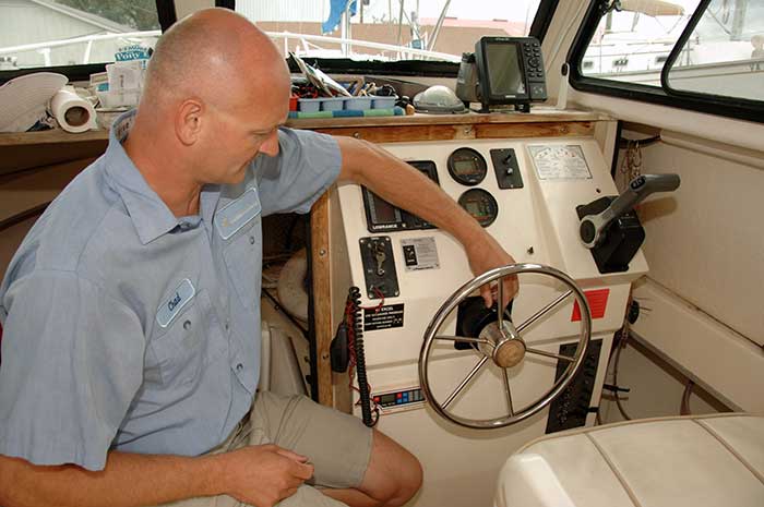 Inspecting hydraulic steering at helm