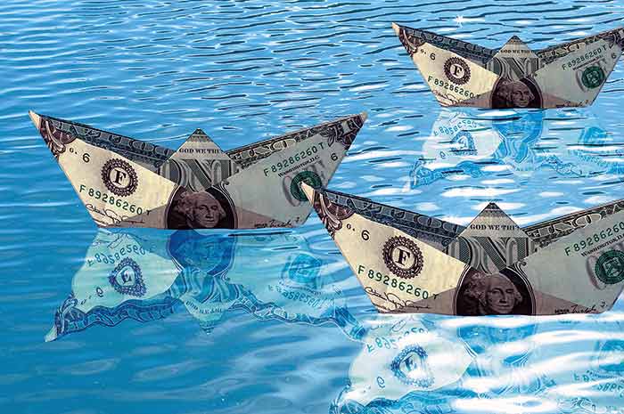 Dollar bills floating on water