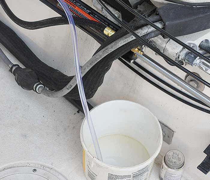 Attached bleeder hose to overflow container