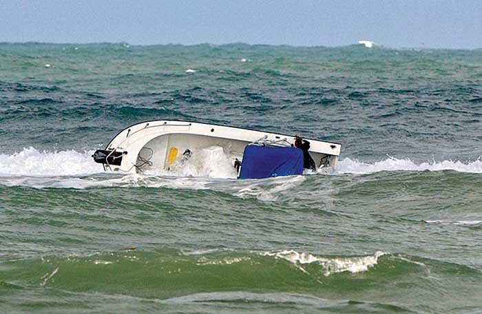 Large wave swamps powerboat