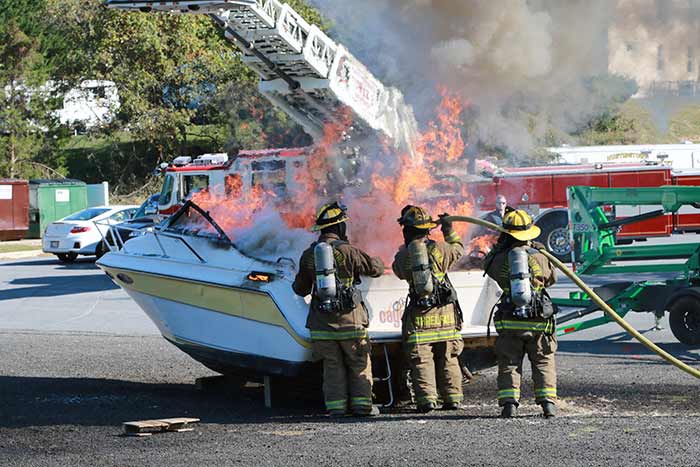 Firefighters putting out boat fire