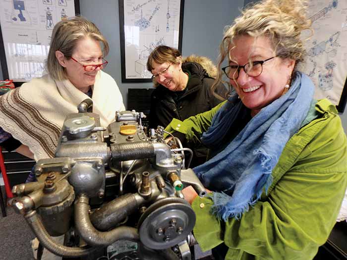 Lesley Davison repairing boat engine