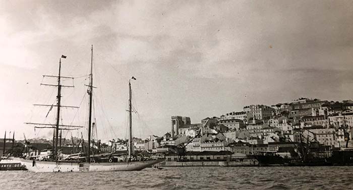 A 142-foot three-masted ship sailing along the coast of Lisbon
