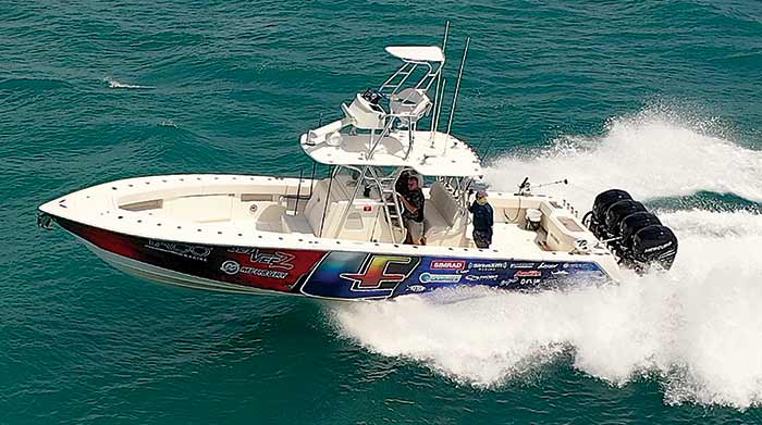 39-foot SeaVee with quadruple outboard engines on transom cruises at full speed throught the water