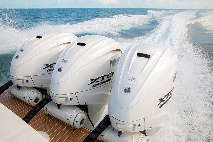 Three Yamaha F450 XTO Offshore outboard engines in action cruising through the blue water