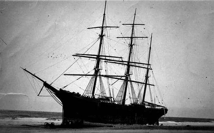 Black and white photo of the British bark Kate Harding wrecked November 30, 1892, on Nauset Beach in Orleans, Massachusetts, on the Outer Shore of Cape Cod, during a fierce storm.