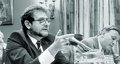 Man at a congressional hearing answering questions