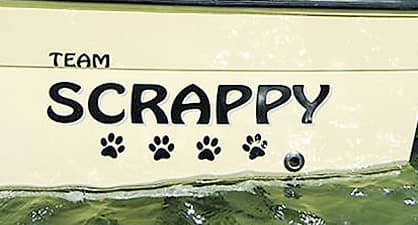 Picture for the back of a yacht named team scrappy with paw prints