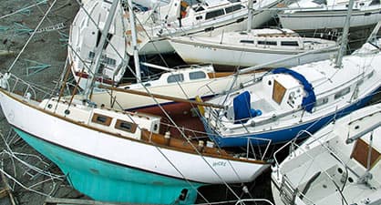 A bunch of yachts stranded on the shore on top of each other due to Hurrican Sandy