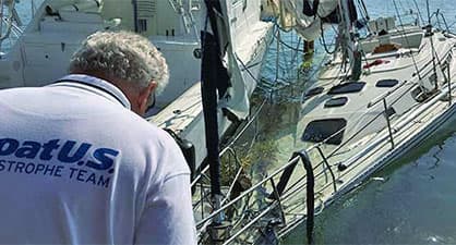 A boatus catastrophe team member observing two wrecked yachts from Hurrican Harvey