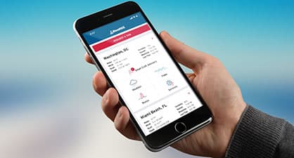 A hand holding an iphone with the boatus app open