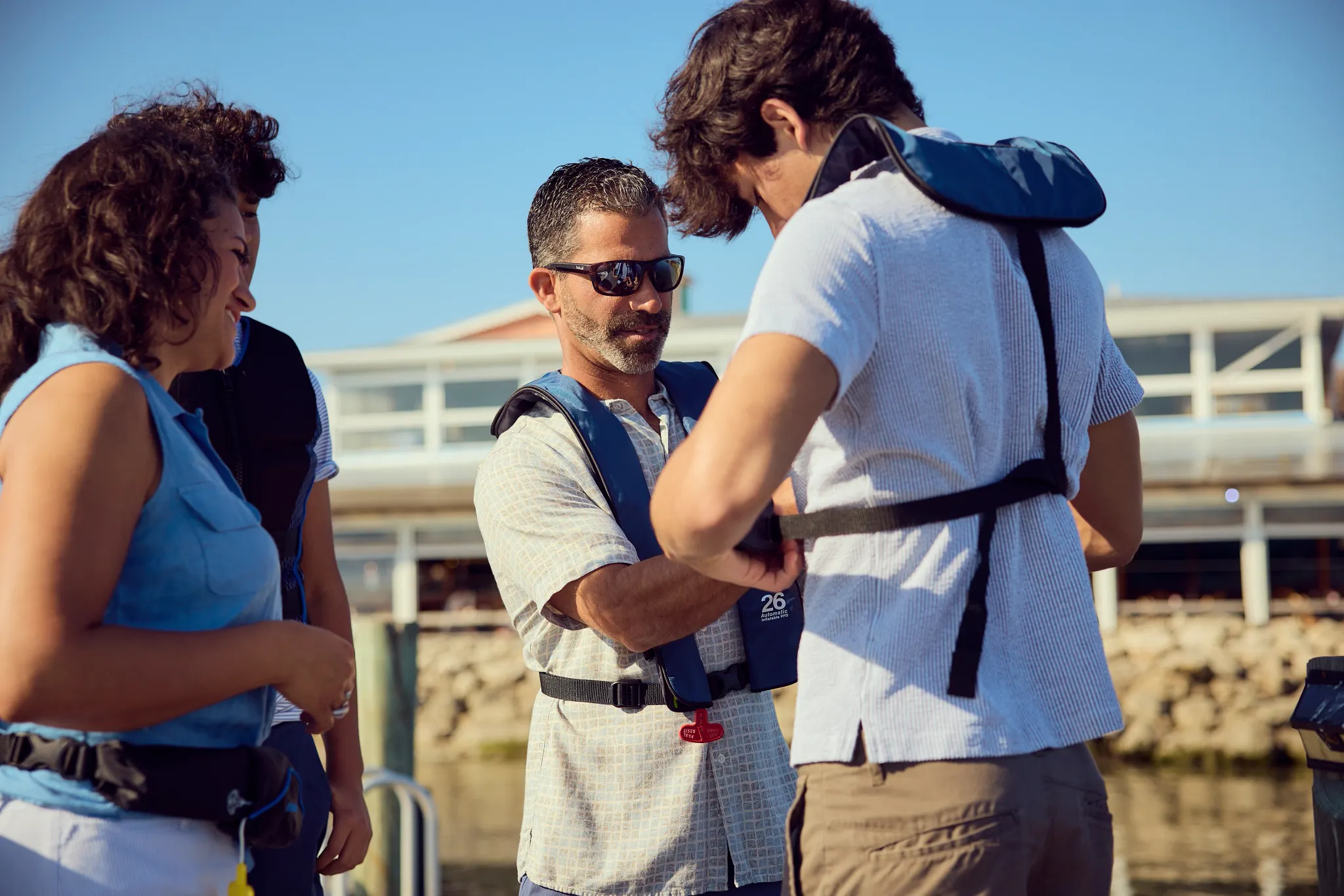 An image of a family wearing properly fitted life jackets 